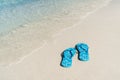 Flip flops on white sandy tropical beach, Summer vacation Royalty Free Stock Photo