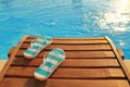 Flip flops on wooden sunbed Royalty Free Stock Photo