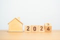 flip 2023 to 2024 block with house model. real estate, Home loan, tax, investment, financial, savings and New Year Resolution Royalty Free Stock Photo