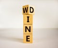 Fliped a wooden cube and changed the inscription `wine` to `dine` or vice versa. Beautiful white background, copy space Royalty Free Stock Photo