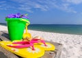 Flipflops and bucket on boardwalk Royalty Free Stock Photo