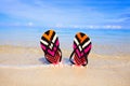 Flipflops. Colorful flipflops in the sand.Summertime and travel.