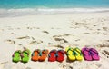 Flipflops on a sandy ocean beach. Royalty Free Stock Photo