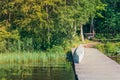 Flipped over wooden canoe on river pier