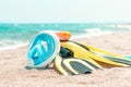 Flippers, diving mask, snorkeling accessories on the beach during sunny day closeup against sea background. Background for summer Royalty Free Stock Photo