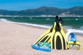 Flippers, diving mask, snorkeling accessories on the beach during sunny day closeup against sea background. Background for summer Royalty Free Stock Photo