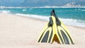Flippers, diving mask, snorkeling accessories on the beach during sunny day closeup against sea background. Background Royalty Free Stock Photo