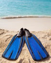 Flippers lay on sand on background of ocean Royalty Free Stock Photo