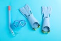 Flippers, snorkel and diving mask on blue background Royalty Free Stock Photo