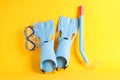 Flippers, snorkel and diving mask on yellow background Royalty Free Stock Photo