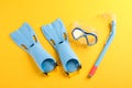 Flippers, snorkel and diving mask on yellow background Royalty Free Stock Photo
