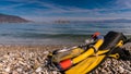 Flippers and snorkeling tube on sea shore Royalty Free Stock Photo