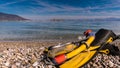 Flippers and snorkeling tube on sea shore Royalty Free Stock Photo