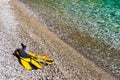 Flippers and snorkeling tube on sea shore Royalty Free Stock Photo