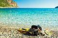 Flippers and snorkeling tube on sea shore Royalty Free Stock Photo