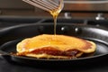 flipping golden pancakes in a hot non-stick pan