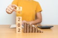 flipping 2023 to 2024 year block with Coins stack. Money, Budget, tax, investment, financial, savings and New Year Resolution