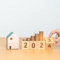 2023 flipping to 2024 year block with house model and Coins stack. real estate, Home loan, tax, investment, mortgage, financial, Royalty Free Stock Photo