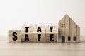 Flipping wooden blocks change wording stay and safe with wooden home. Stay home to prevent COVID 19 out break