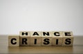 Flipping wooden cubes for change wording` Crisis ` to ` Chance`.