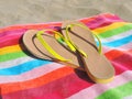 Flips Flops on a striped beach towel Royalty Free Stock Photo
