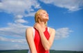 Flirt and coquette concept. Sunlight pleasant warm. Woman red dress feels carefree and free. Girl blonde lady smiling Royalty Free Stock Photo