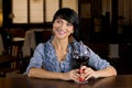 Flirtatious young woman drinking at a bar