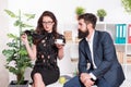 Flirting colleagues. Bearded man and attractive woman. Man and woman conversation during lunch time. Office rumors