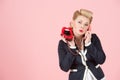 A Flirting portrait of blonde girl with phone in pin-up make-up with copyspace area for advertising text message