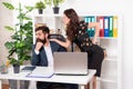 Flirting at work. Assistant flirting with manager sitting on desk. Flirty woman and shy man Royalty Free Stock Photo