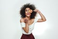 Flirting with you. Cute and positive afro american woman covering one eye with lollipop and sending air kiss while Royalty Free Stock Photo