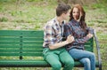 Flirting young couple on a bench