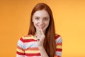 Flirty devious creative young redhead smiling excited ginger girl prepare mysterious gift surprise party giggling tricky Royalty Free Stock Photo