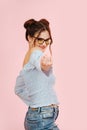 Flirty eccentric lady inviting someone with her finger. Over pink background. Royalty Free Stock Photo