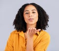 Flirty, happy and a portrait of a woman blowing kiss isolated on a studio background. Love, smile and a flirtatious girl