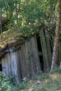 Abandoned wooden farm house with grass roof in the woods Royalty Free Stock Photo