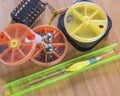 Fishing tackle - coil with fishing line, float and wooden background boxes