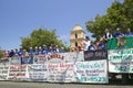 Float of a Little League baseball team with sponsor advertisements makes its way down main street during a Fourth of July parade