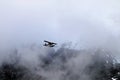 Plane flying in mountains in Glacier National Park Alaska Royalty Free Stock Photo