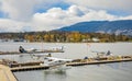 Float planes docked at Vancouver's Harbour Airport in overcast day. Air seaplanes at Vancouver Harbour Flight