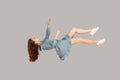 Floating in air. Relaxed girl in vintage ruffle dress levitating keeping eyes closed, sleeping while flying mid-air