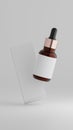 Floating amber dropper bottle with packaging box isolated on a plain white background Royalty Free Stock Photo