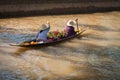 Floating asian vendors on long wooden boat Royalty Free Stock Photo