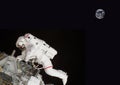 Floating astronaut in space composite image some elements courtesy of nasa