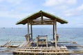 Floating beach bamboo and palm cottage parasol on white sand coast
