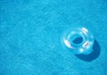 Floating blue inflatable ring in clear swimming pool water Royalty Free Stock Photo