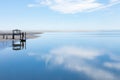 Floating boat dock at low tide, blue sky reflected in still water of intracoastal waterway, Tybee Island Georgia USA Royalty Free Stock Photo