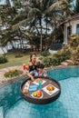 Floating breakfast in infinity pool on paradise swimming pool, morning in the tropical resort bungalow Royalty Free Stock Photo