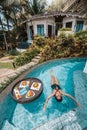 Floating breakfast in infinity pool on paradise swimming pool, morning in the tropical resort bungalow Royalty Free Stock Photo