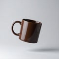 Floating Brown Ceramic Coffee Mug with Glossy Surface on White Background Royalty Free Stock Photo